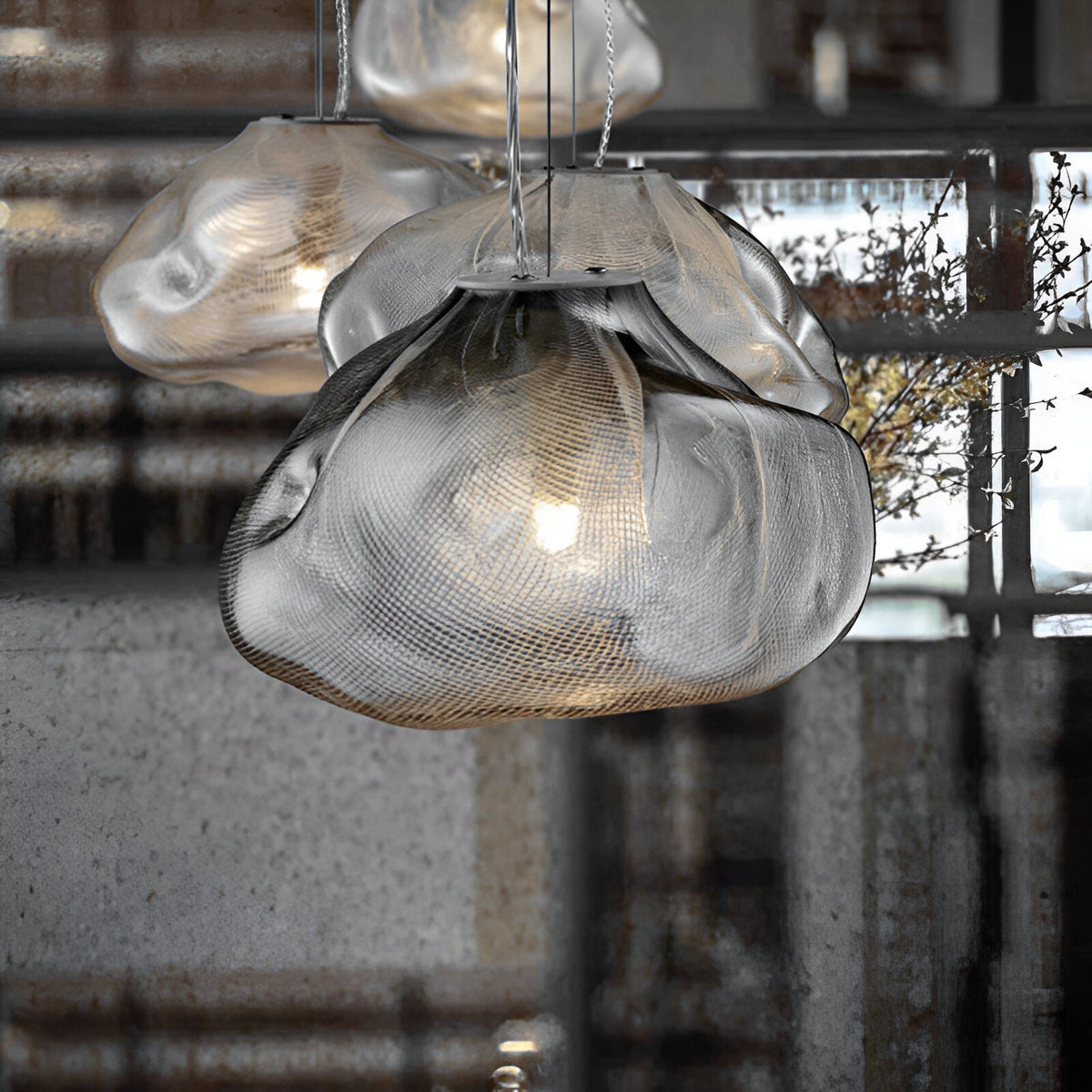 Grey cloud-shaped glass shade viewed close up