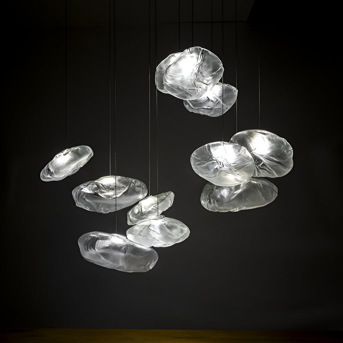 Grouped illuminated clear cloud glass pendants