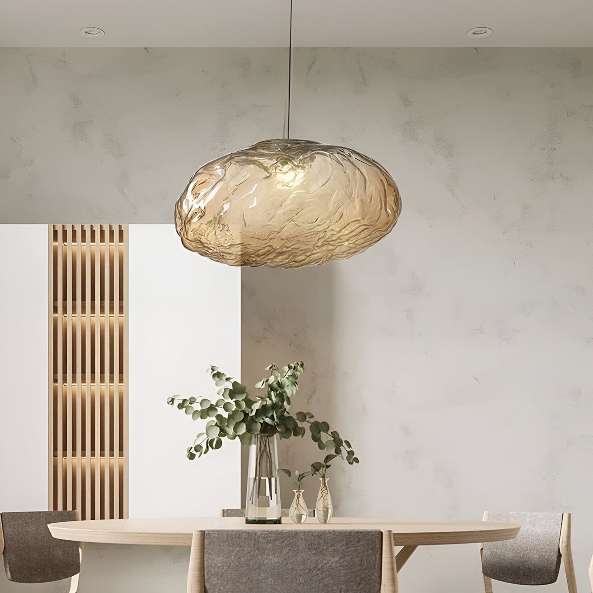 Brown glass cloud pendant above a dining table