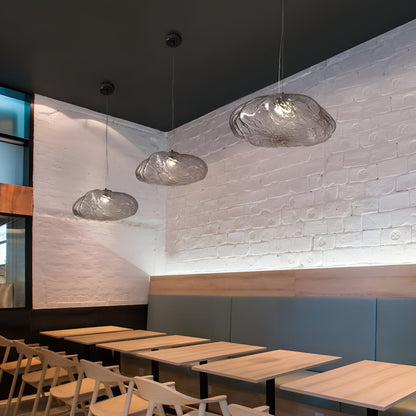Glass cloud pendants above restaurant tables