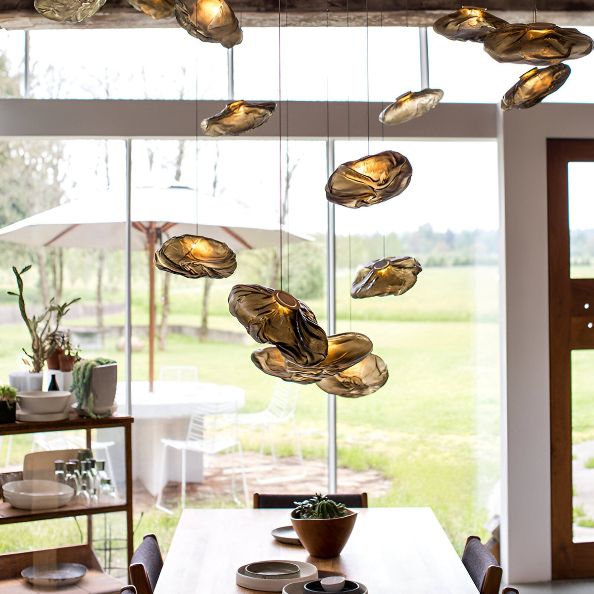 Grouped brown glass cloud pendants above a dining area