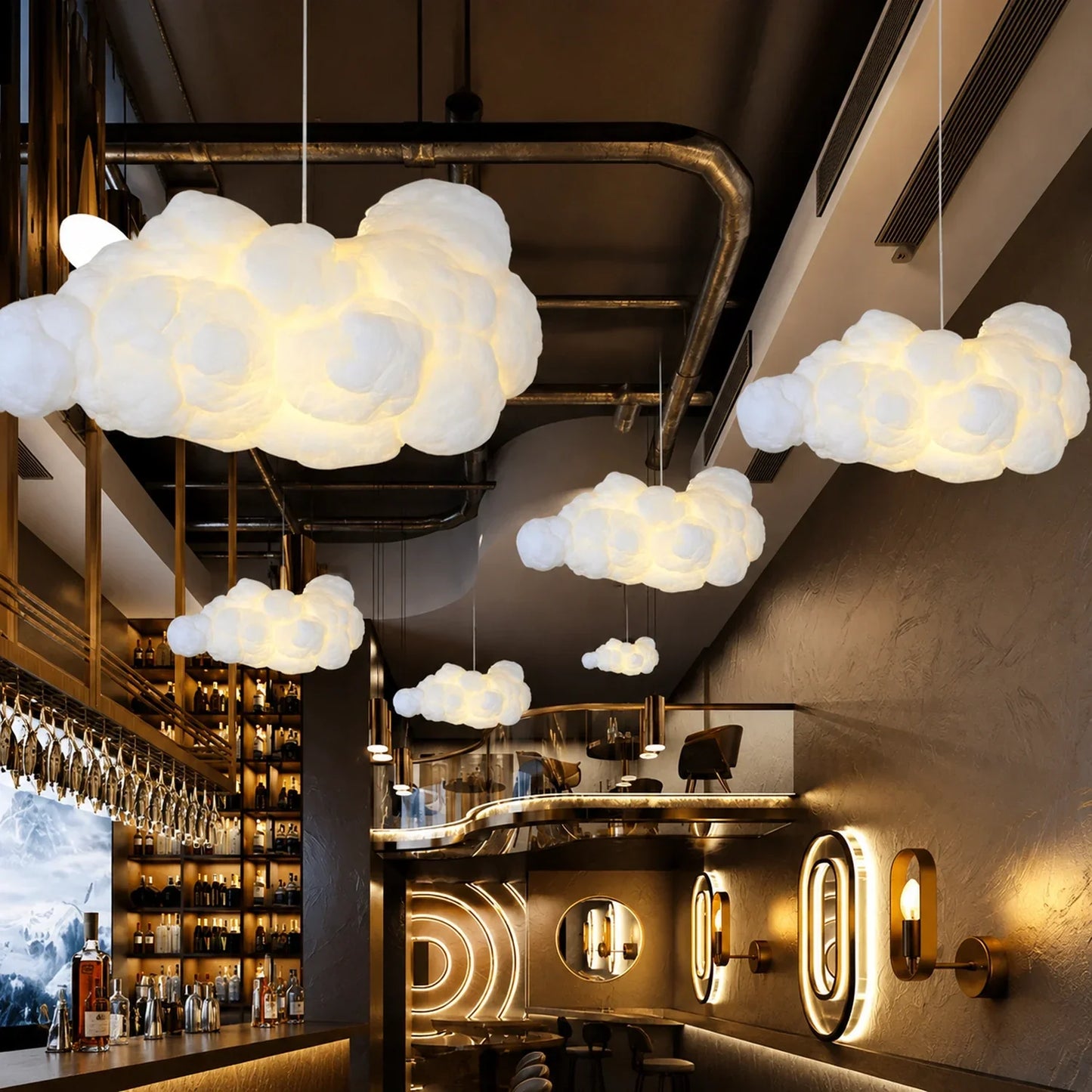 Multiple sculptural cloud pendant lights glowing in a modern bar interior with dark walls, industrial ceiling pipes and warm ambient wall lighting.