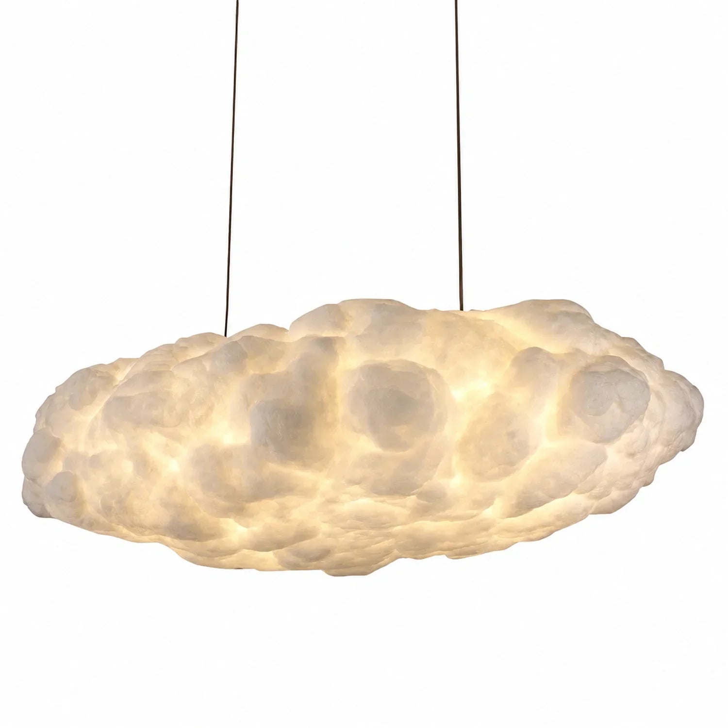 Modern sculptural cloud pendant light with a soft, glowing interior, suspended by thin wires against a plain white background for interior decor.