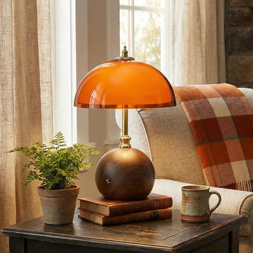 Orange dome rechargeable lamp beside an armchair