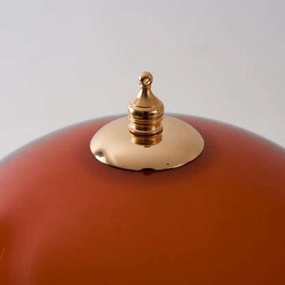 Gold-tone top finial on the Coby lamp