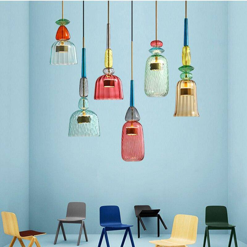 Six decorative glass pendants above colourful chairs