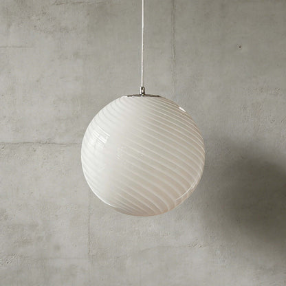 A modern spherical pendant light with a white glass shade featuring a subtle swirling pattern, suspended against a textured grey concrete wall background.