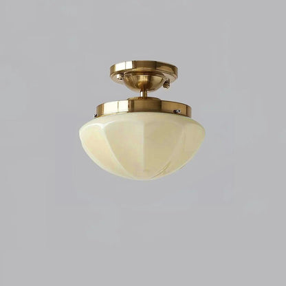 Gold short-stem ceiling light with a beige faceted shade