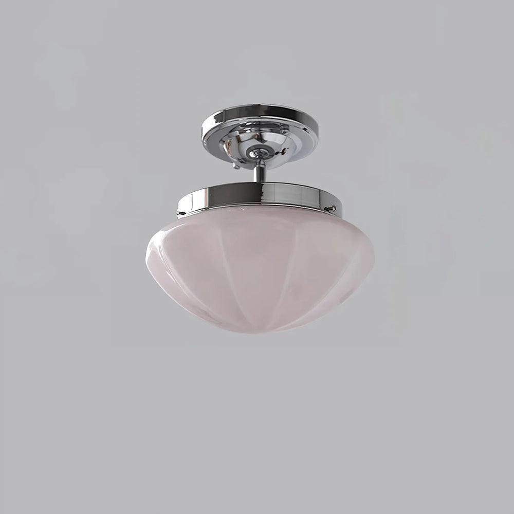 Chrome short-stem ceiling light with a pink faceted shade
