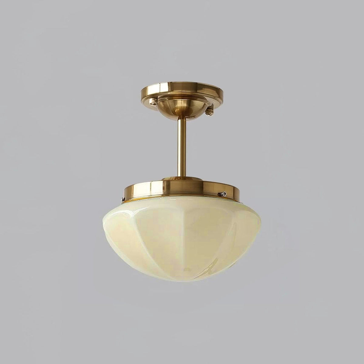 Gold long-stem ceiling light with a beige faceted shade