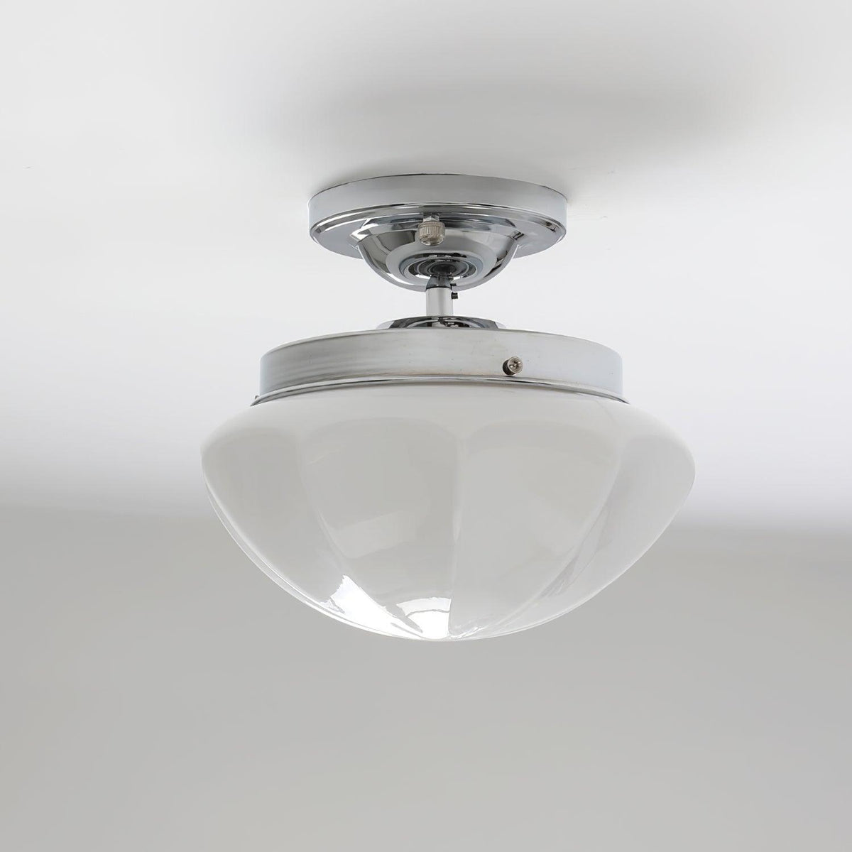Chrome compact ceiling light with a white faceted shade