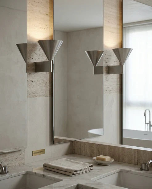 Aluminum cone wall sconces beside a mirror