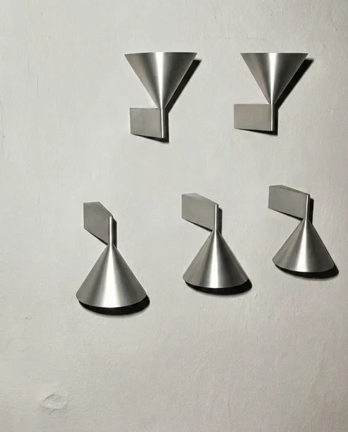 Cone sconce orientations in aluminum finish