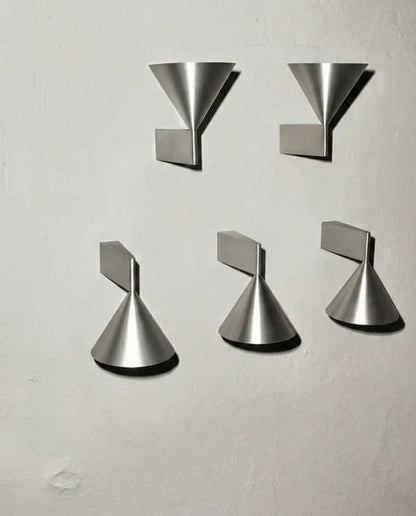 Cone sconce orientations in aluminum finish