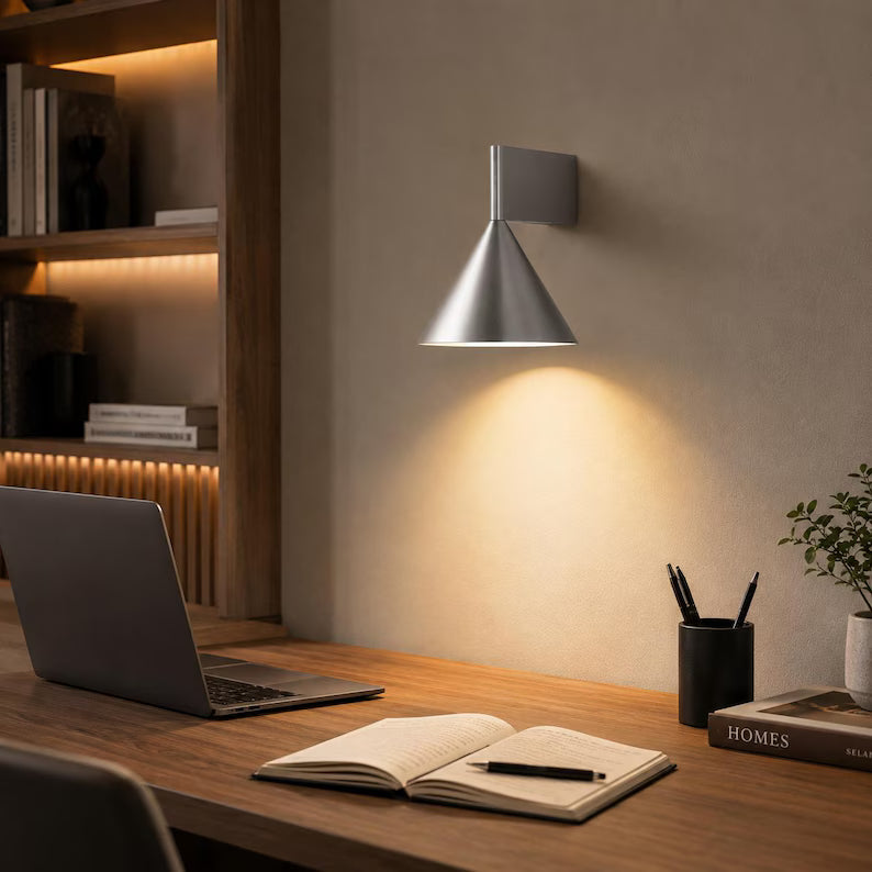 Aluminum cone lamp above a desk