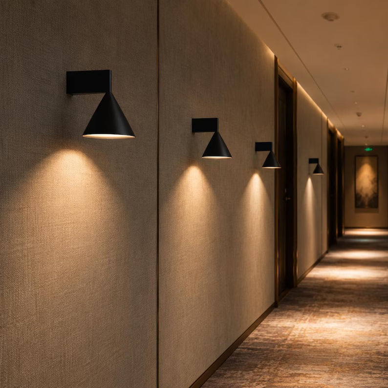 Black cone sconces along a hallway