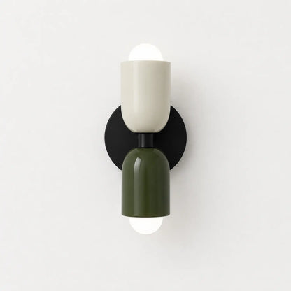 Contemporary dual-cylinder wall lamp featuring a cream and olive green finish with a black circular mount, providing up and down ambient lighting.