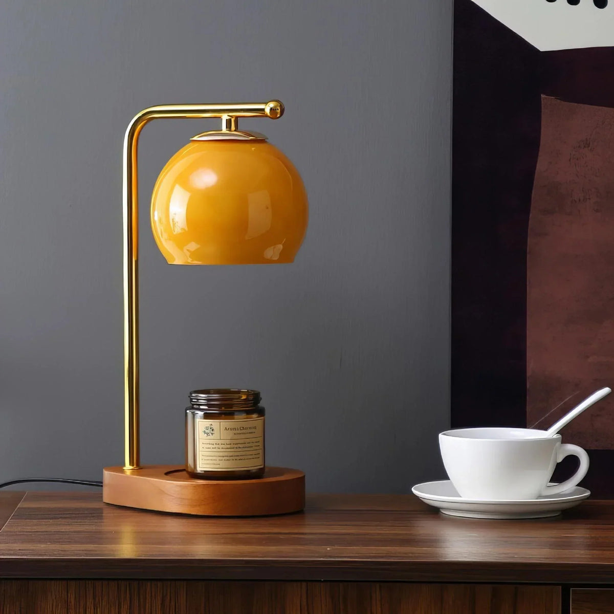 Amber glass candle warmer with a dark round base