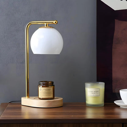 White glass globe candle warmer with a pale round base