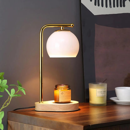 Illuminated white glass candle warmer above a jar candle