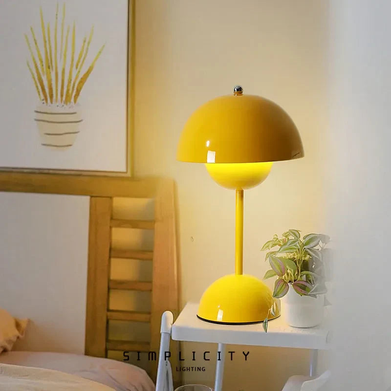 Yellow dome table lamp near a bed