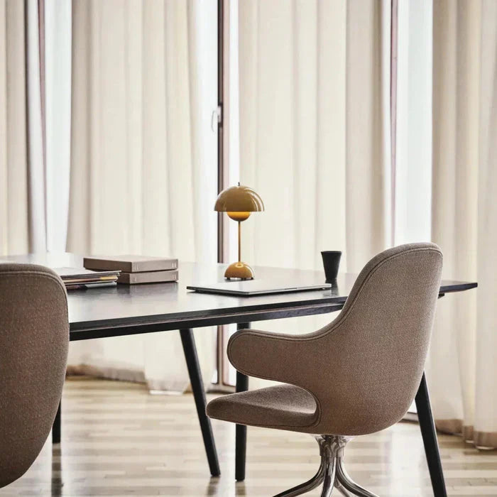 Small dome lamp on a desk near a window
