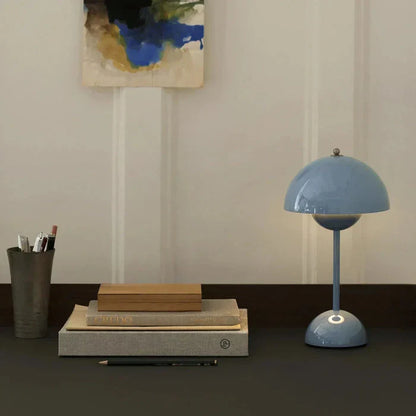 Blue dome table lamp beside books