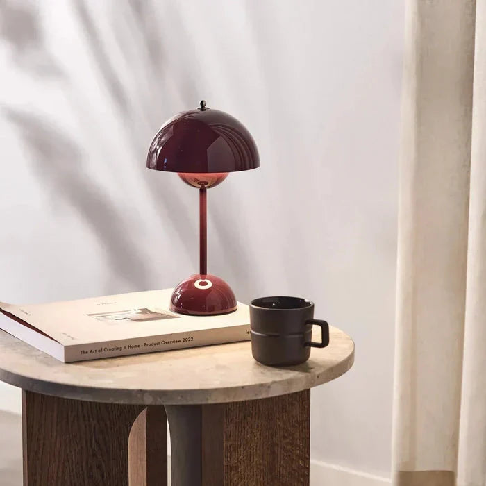 Red dome table lamp on a side table