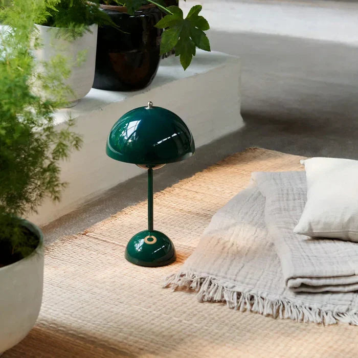 Green cordless dome table lamp on a fabric-covered surface
