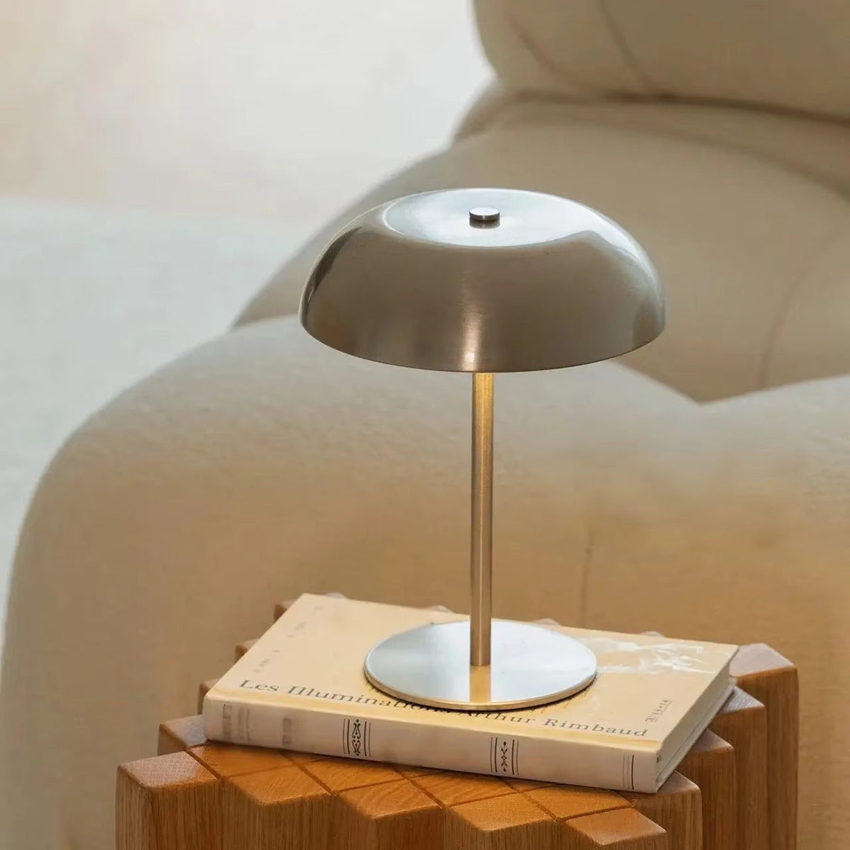 Touch-control metal lamp beside a sofa