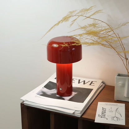 Red mushroom table lamp on books