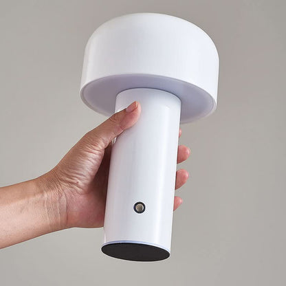 White mushroom lamp held in a hand