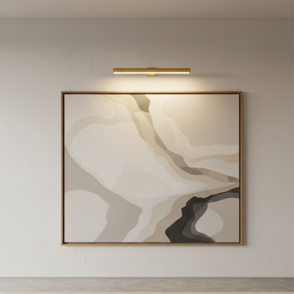 Gold picture light illuminating a large abstract artwork