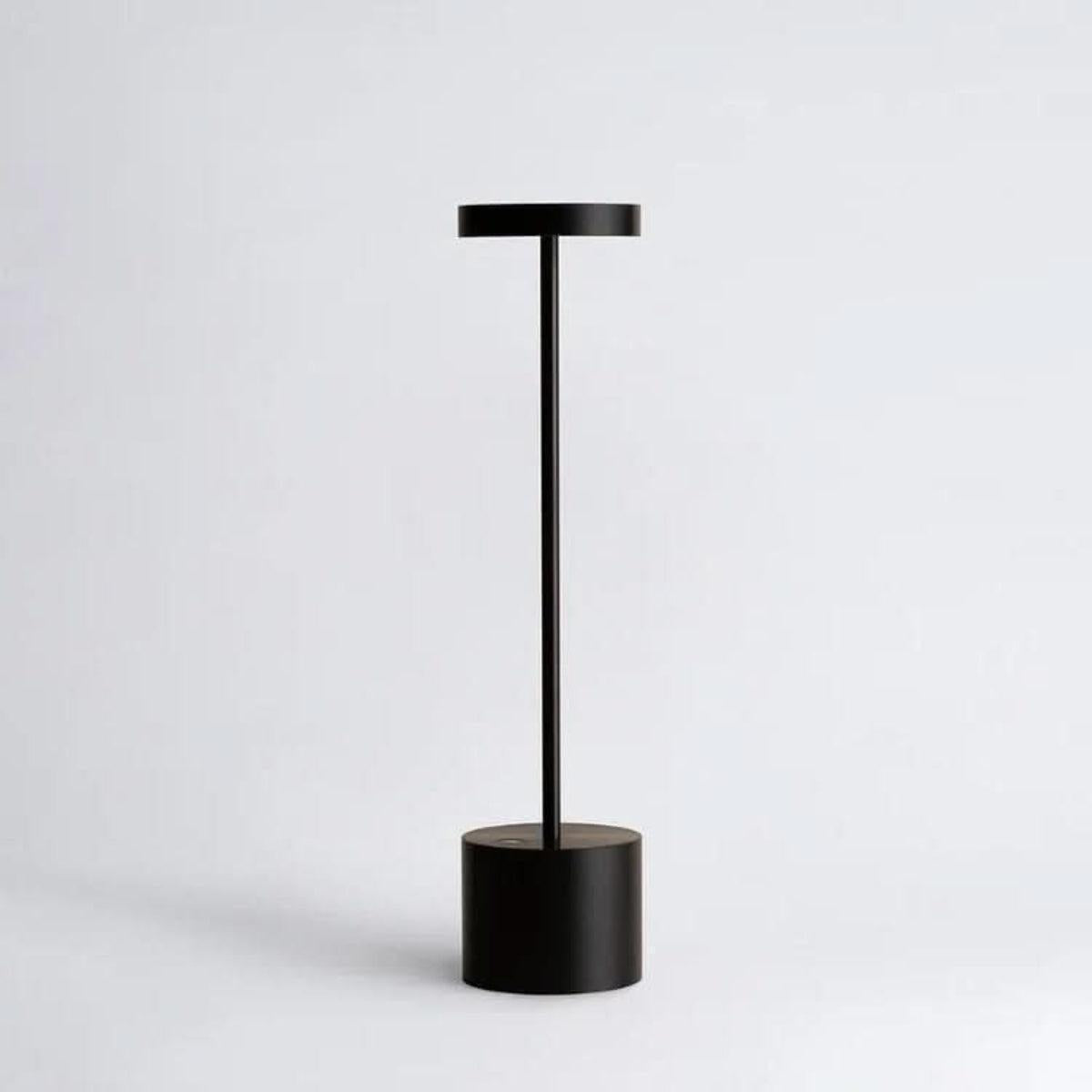 Black rechargeable table lamp with a slim stem and cylindrical base