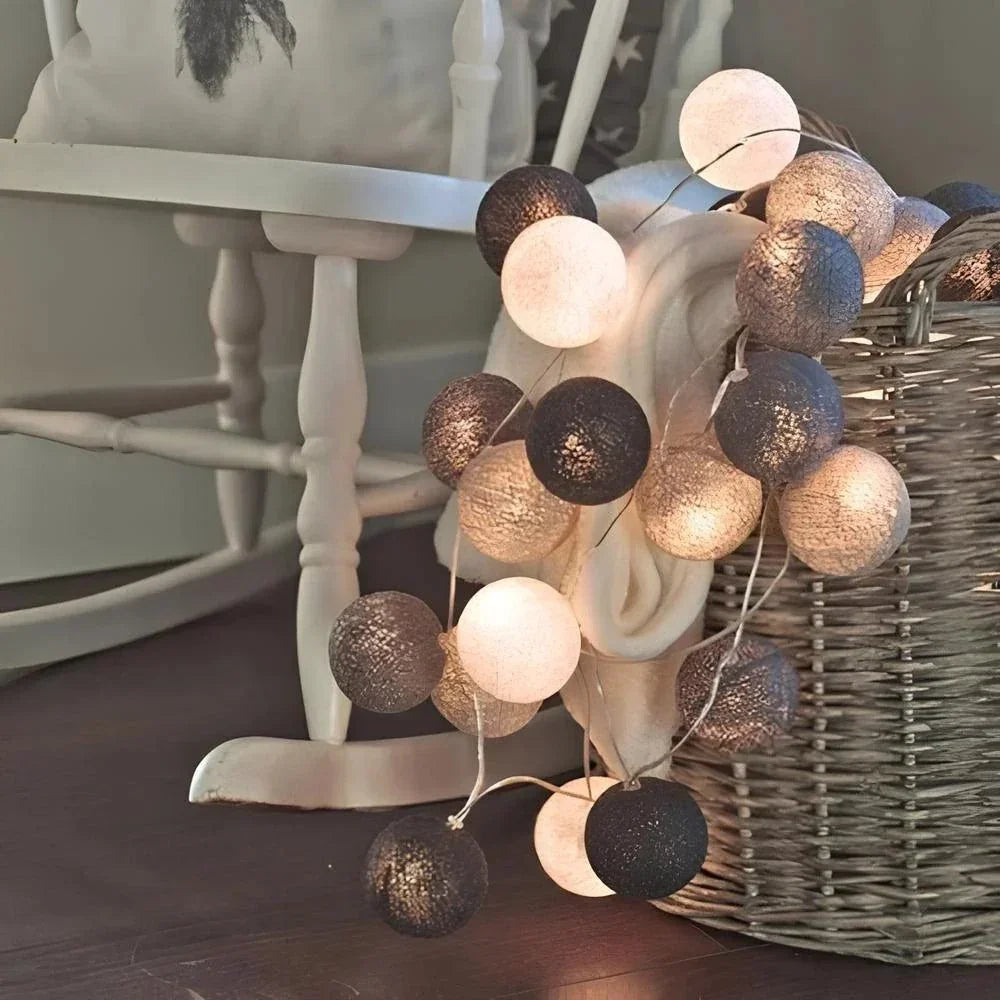 Grey and white cotton ball lights on a chair
