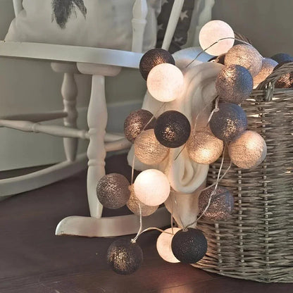 Grey and white cotton ball lights on a chair