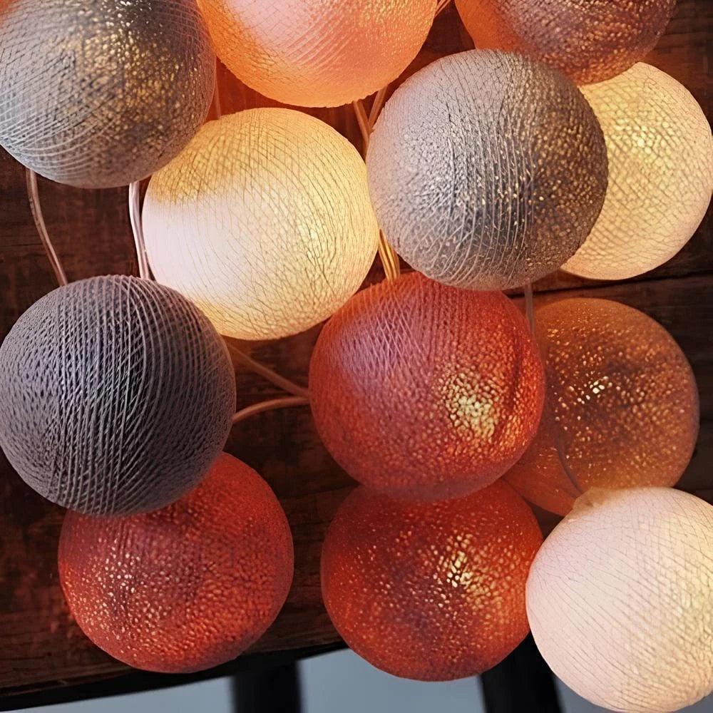 Close-up of grey, white and burgundy cotton ball lights