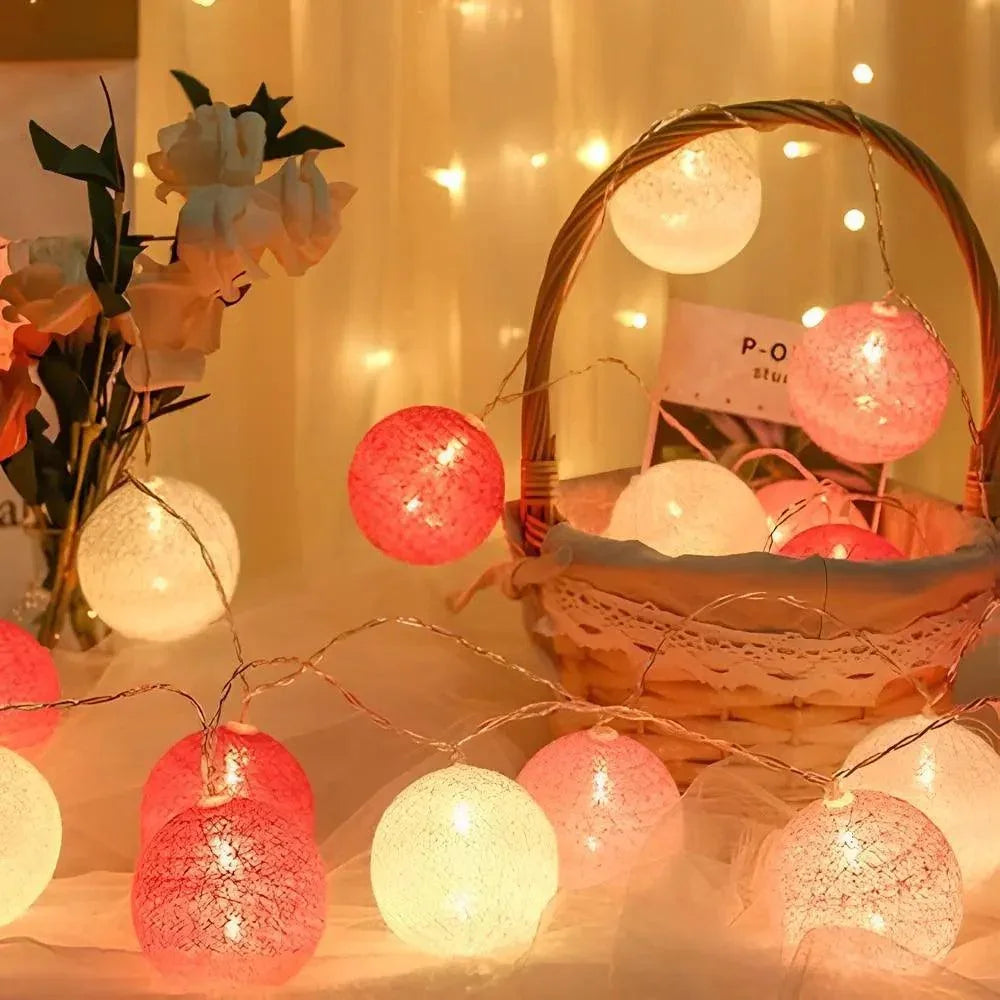 Pink and white cotton ball lights around a woven basket