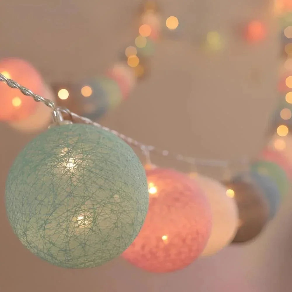 Close-up of glowing pastel cotton thread light balls