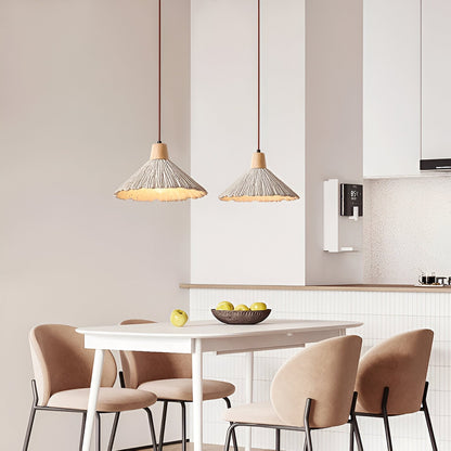 Cream scalloped pendants above a dining table
