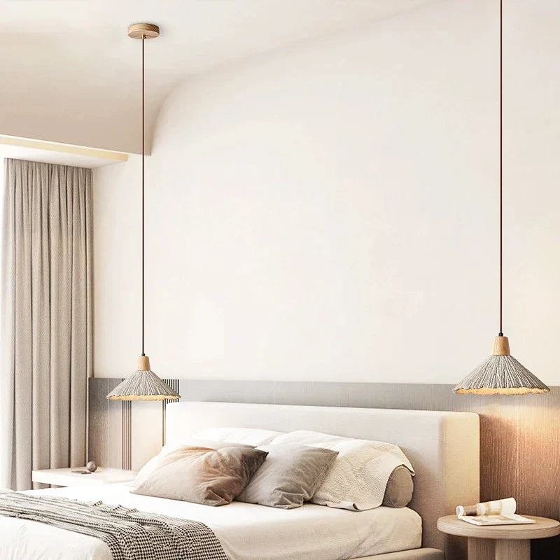 Cream textured pendant lights beside a bed