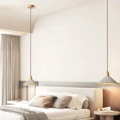 Cream textured pendant lights beside a bed
