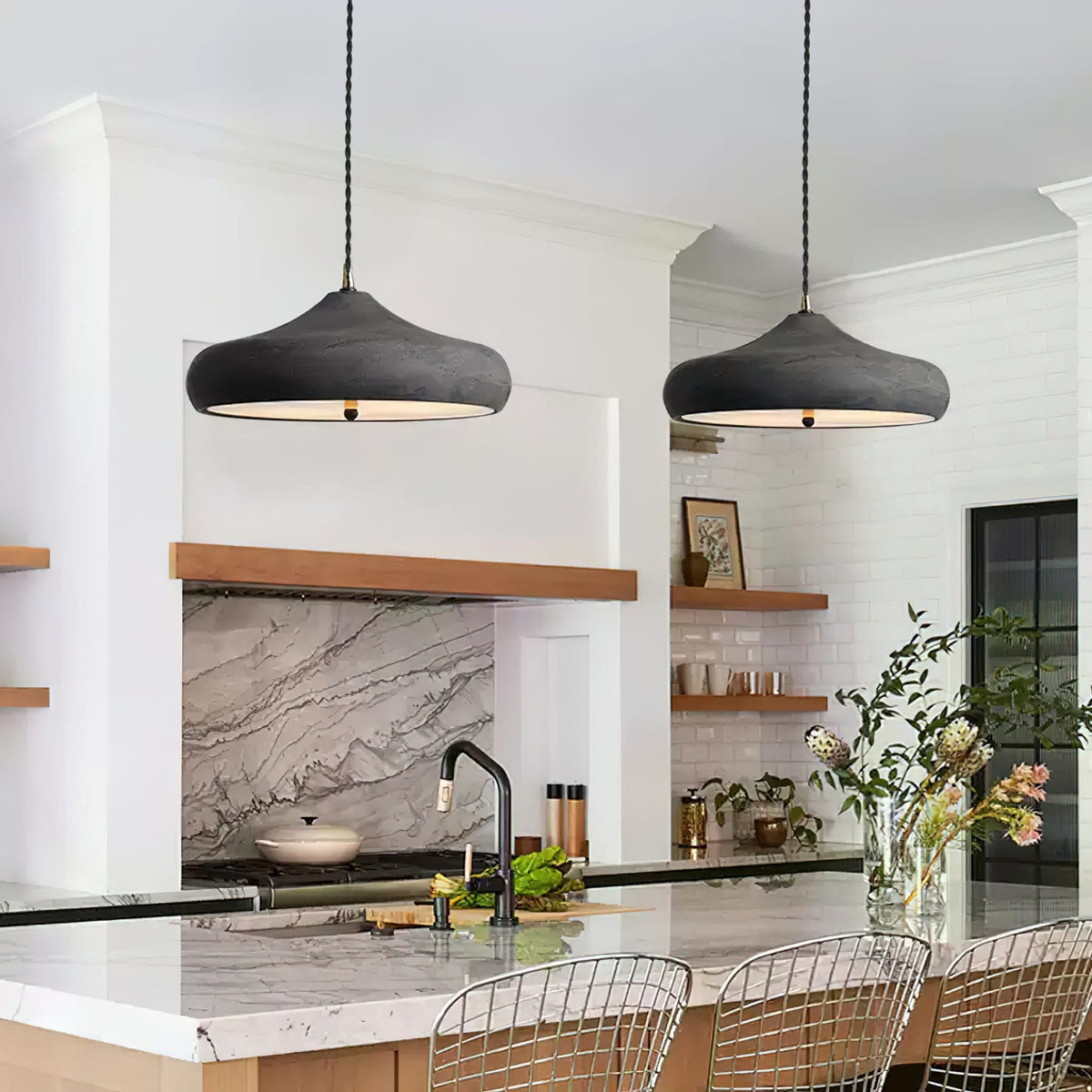 Curved iron pendant shades in a white kitchen