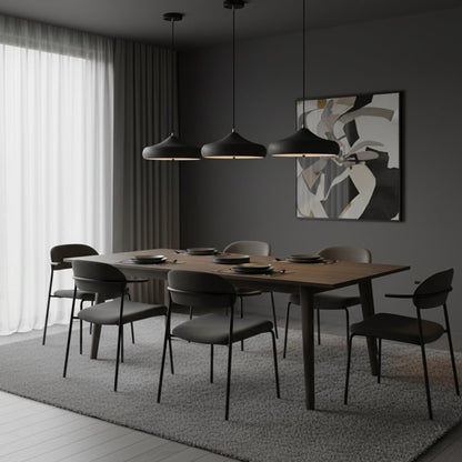 Three curved iron pendants above a dining table