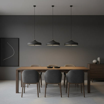 Three dark pendants above a timber dining table