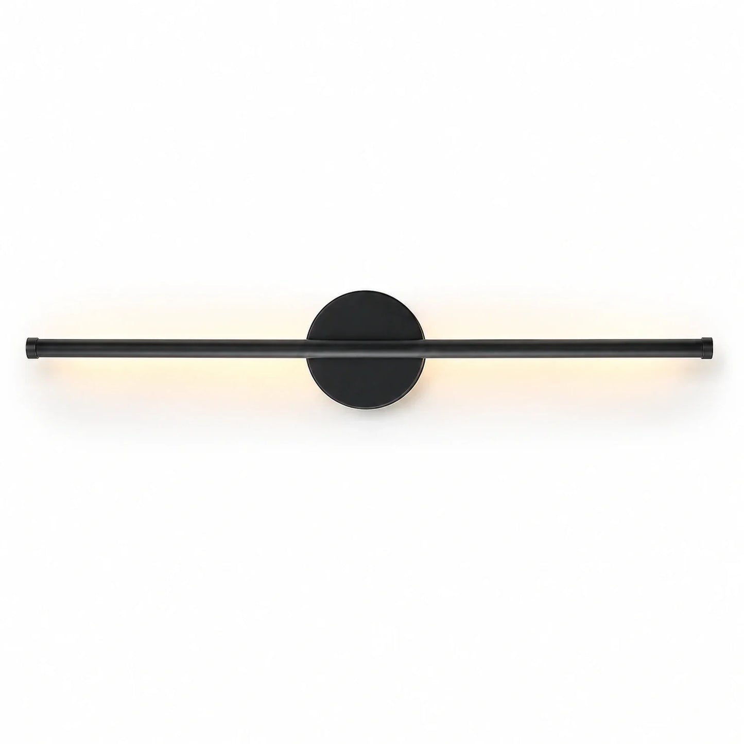 A modern, matte black linear LED wall light with a circular mounting base, emitting a soft, warm glow against a clean white background.