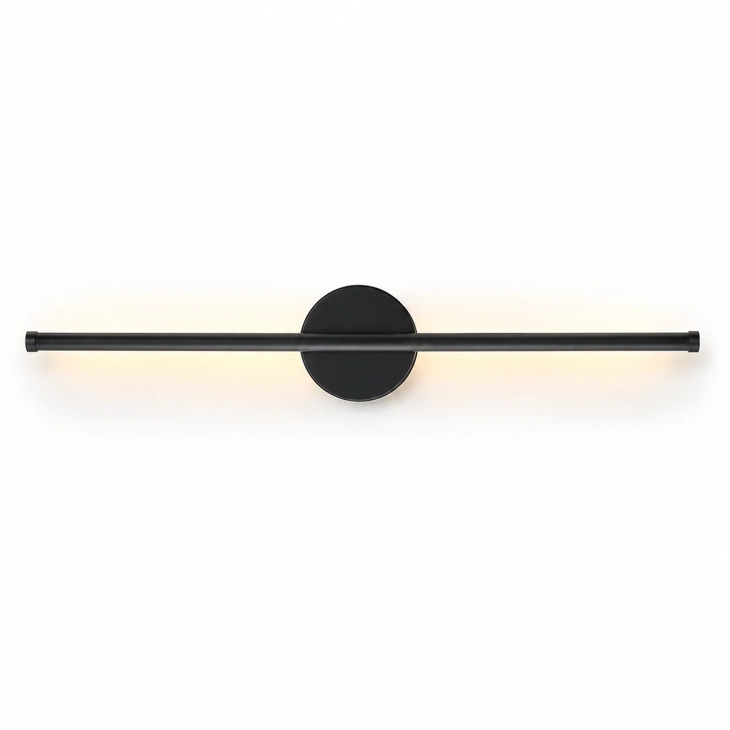 A modern, matte black linear LED wall light with a circular mounting base, emitting a soft, warm glow against a clean white background.