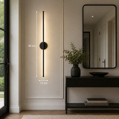 80cm black dimmable LED wall light mounted in a modern hallway, featuring a sleek vertical design with warm illumination and touch control functionality.