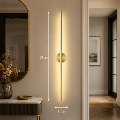 100cm gold dimmable LED wall light mounted on a neutral interior wall, featuring a sleek vertical design with soft ambient lighting for modern homes.