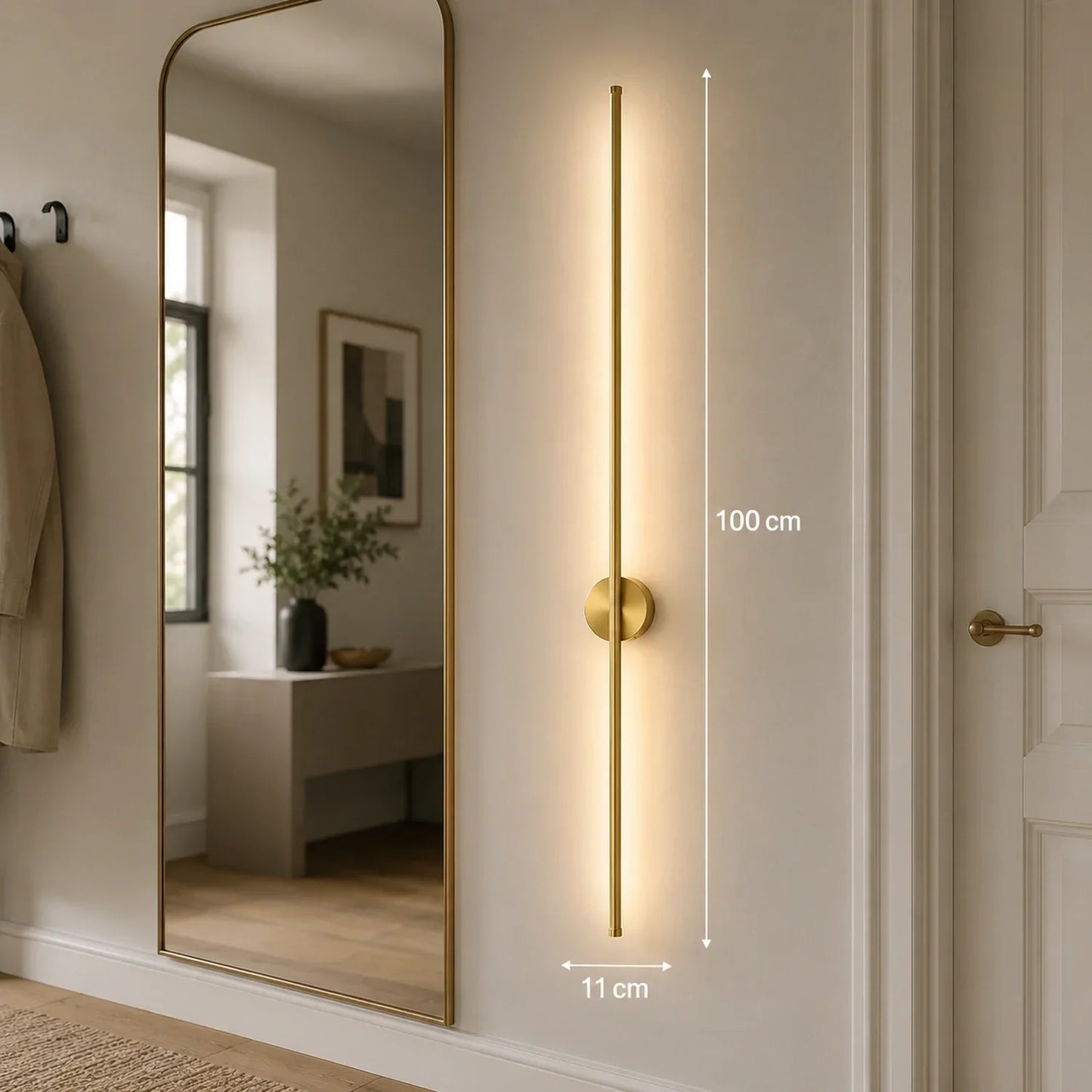 A 100cm gold dimmable LED wall light mounted in a hallway, featuring a slim vertical design with warm illumination and touch control functionality.
